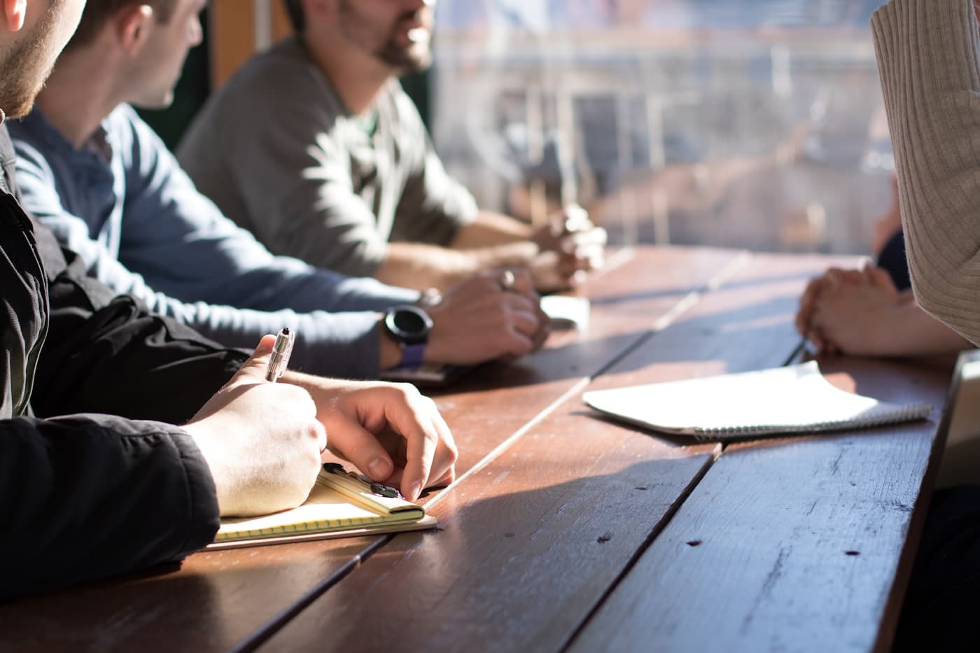 Team in a consulting meeting taking notes